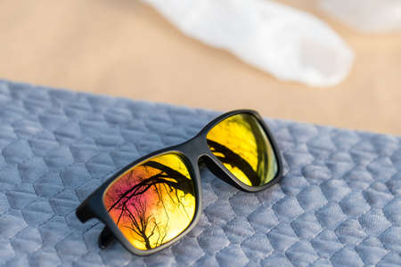 Classic Sunglasses design with golden lenses shoot outdoors in a sunny day closeup. Selective focusの写真素材