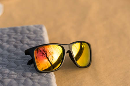 Classic Sunglasses design with golden lenses shoot outdoors in a sunny day closeup. Selective focusの写真素材