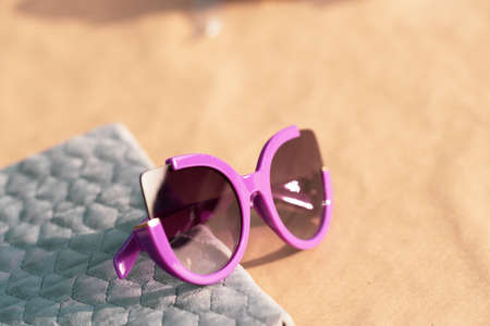 Cat eye sunglasses special model for women pink color shoot outside in a summer day closeup. Selective focusの写真素材