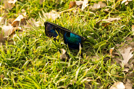 Classic Sunglasses model with green lenses shoot outside in nature in a summer day. Selective focusの写真素材