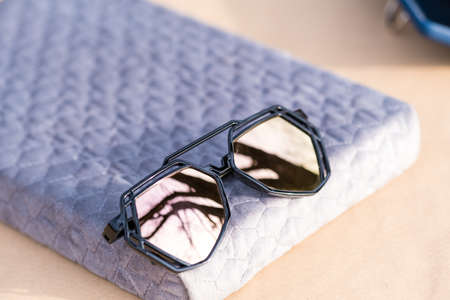 Futuristic aviator sunglasses model with big pink lenses closeup shoot outside in a summer day . Selective focusの写真素材