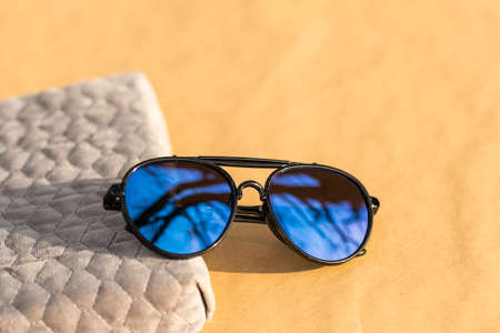 Aviator Sunglasses special model with big blue lenses reflecting the sun in a summer day shoot outdoors closeup . Selective focusの写真素材