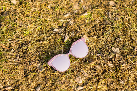 Pink Sunglasses model for women with a very special design shoot outside in nature in a summer day . Selective focusの写真素材