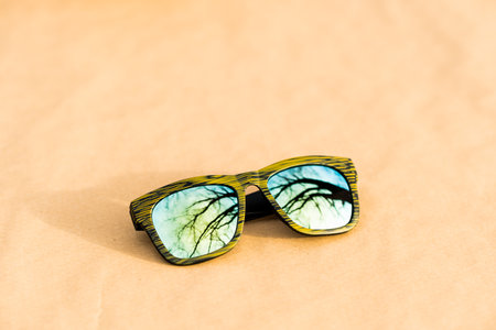 Classic sunglasses model with reflecting lenses and green frame in a sunny day closeup . Selective focusの写真素材