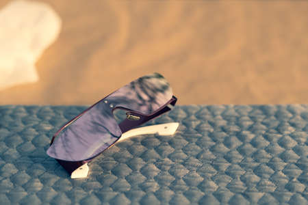 Special Design sunglasses with pink lenses shoot outside in a summer day closeup. Selective Focus.の写真素材