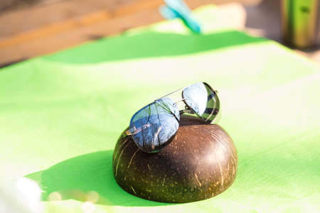 Aviator sunglasses model with big silver lenses shoot outside in a sunny day closeup . Selective focusの写真素材