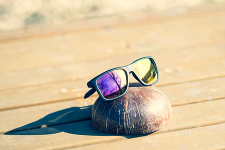 Classic Sunglasses sport model with colored lenses shoot outside in a summer day closeup. Selective focusの写真素材