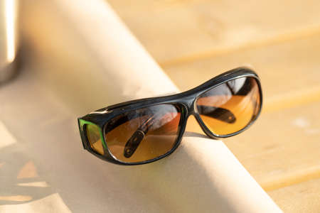 Sunglasses with yellow lenses special for driving. Shoot in a summer day outside closeupの写真素材