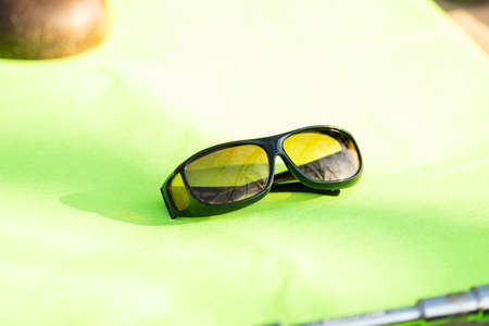 Sunglasses with yellow lenses special for driving. Shoot in a summer day outside closeupの写真素材