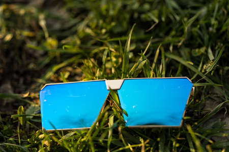 Oversized sunglasses model with blue lenses shoot outside in a sumer day closeup . Selective focusの写真素材