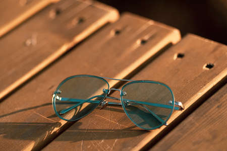 Aviator Sunglasses model with big green lenses for men shoot outside in a summer day closeup . Selective focusの写真素材