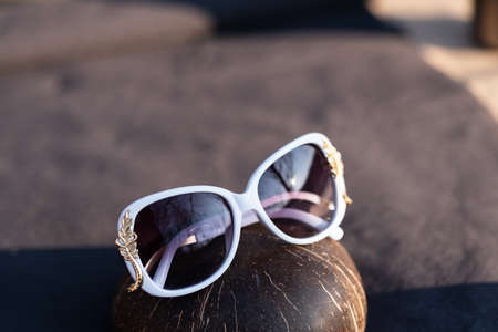 Sunglasses white model for women with a special design shoot outside in nature in a sunny day . Selective focusの写真素材