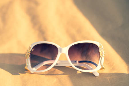 Sunglasses white model for women with a special design shoot outside in nature in a sunny day . Selective focusの写真素材