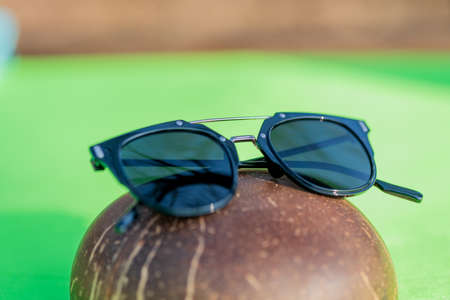 Black sunglasses classic design with black lenses and black frame shoot in a sunny day of summer closeup. Selective Focusの写真素材