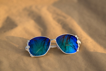 Fashion Sunglasses model with big blue lenses for women with a special design shoot outside in nature in a summer day . Selective focusの写真素材