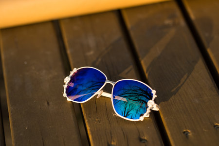 Fashion Sunglasses model with big blue lenses for women with a special design shoot outside in nature in a summer day . Selective focusの写真素材