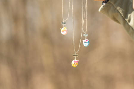 Three pendants best friends necklace shoot outside in a summer day closeup. Selective Focusの写真素材