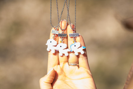 Pendant set of best friends forever three unicorns necklace shoot outside in a summer day closeup....