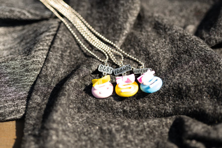 Three colored pendants best friends necklace shoot outside in a summer day closeup. Selective Focusの写真素材