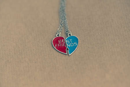 Pendant set of best friends two colors heart necklace shoot outside in a summer day closeup....