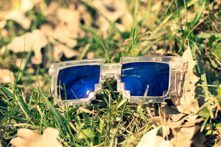 Blue lenses pixel sunglasses model shoot in a summer day closeup. Selective focus