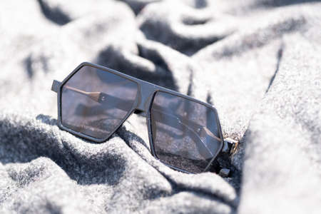 Futuristic oversized sunglasses model with black lenses and black frame shoot outdoor in a sunny day...