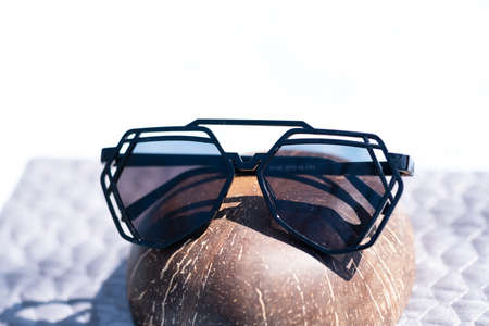 Futuristic sunglasses design with big black lenses closeup shoot outside in a summer day . Selective focusの写真素材