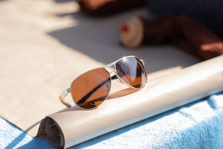 Aviator sunglasses model with big brown lenses shoot outside in a summer day closeup . Selective focusの写真素材