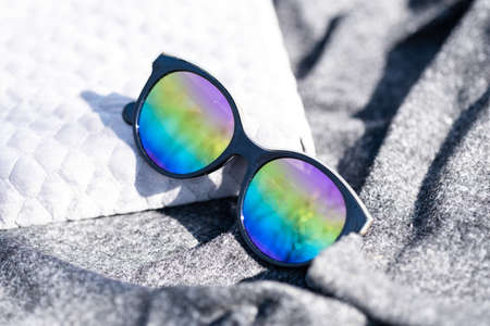 Fashion cat eye sunglasses model for ladies with big round colored lenses and black frame shoot outside in a sunny day closeup. Selective focusの写真素材