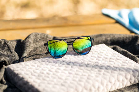 Cat eye sunglasses special model with colored lenses and black frame shoot in a sunny day closeup. Selective focusの写真素材