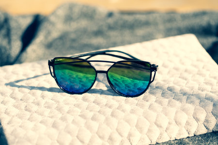 Cat eye sunglasses special model with colored lenses and black frame shoot in a sunny day closeup. Selective focusの写真素材