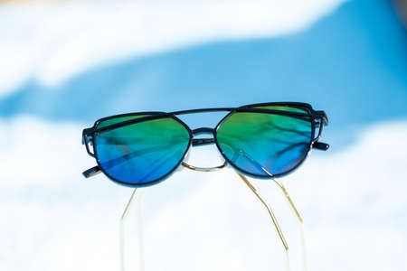 Cat eye sunglasses special model with colored lenses and black frame shoot in a sunny day closeup. Selective focusの写真素材