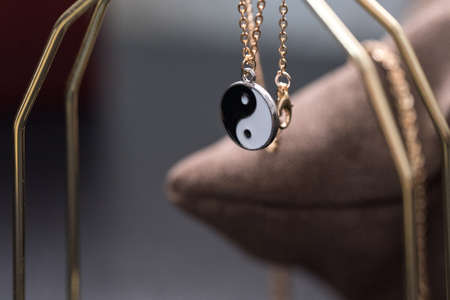 Yin Yang pendant necklace handmade black and white closeup. Selective Focus