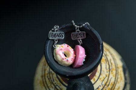 Pendant set of best friends two donuts necklace closeup. Selective Focusの写真素材