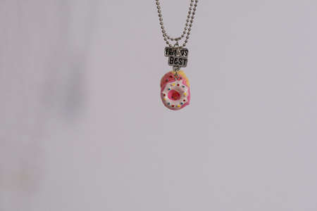 Pendant set of best friends two donuts necklace closeup. Selective Focus