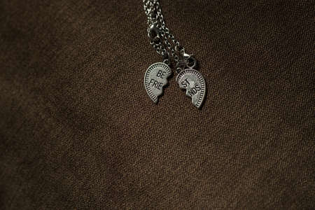 Pendant of best friends heart in two parts necklace closeup. Selective Focus