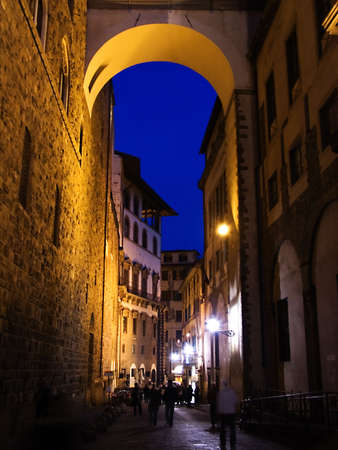 Arch reflecting a golden light onto the street below in Florence, Italyの写真素材
