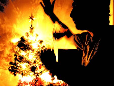 Silhouette of man toasting the festive season with christmas decorationsの写真素材