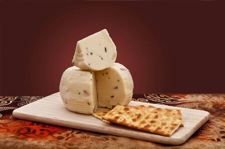 Truffle cheese and crackers on a cutting board