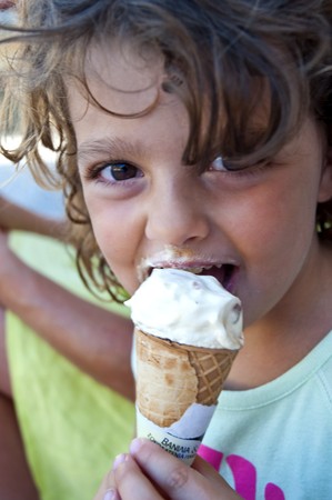 Close up of a girl who is eating an ice creamの写真素材