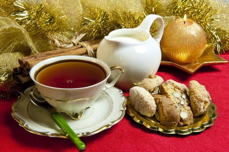 tea and cookies with Christmas decorations on red backgroundの写真素材