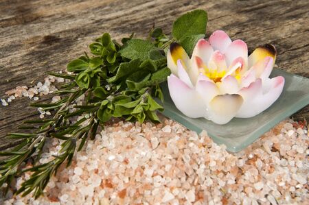 herbs, aromatic salt and aromatherapy products on wooden backgroundの写真素材