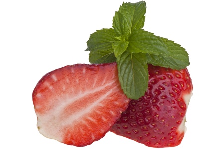 halved strawberry and mint leaves on white backgroundの写真素材