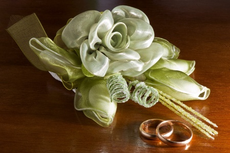 wedding favors and wedding rings on a dark wood tableの写真素材