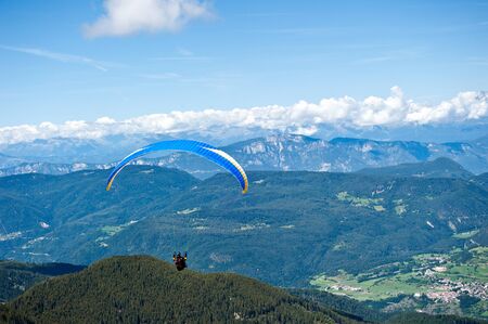 Paraglider flying over the Alps of Trentinoの写真素材