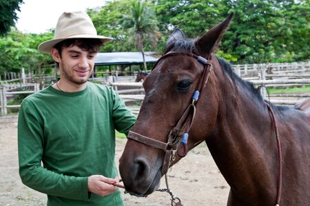 Horses and riders on a farm in Ecuadorの写真素材