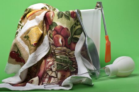 Some kitchen utensils on a green background の写真素材