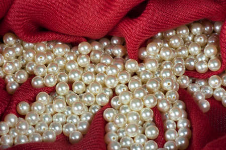 pearls scattered on a colored background fabricの写真素材
