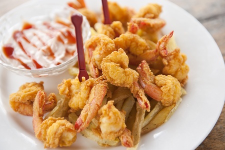 a plate of fried shrimp with fries