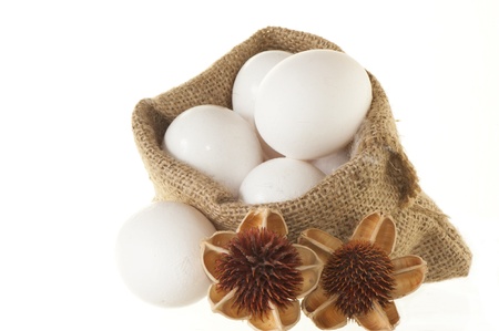 natural basket with eggs and flowers on a white background